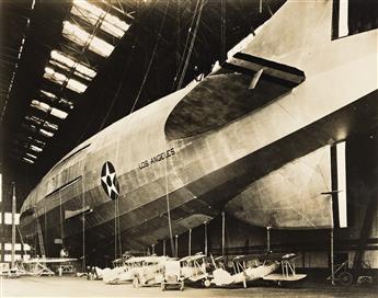 (DIRIGIBLES) A group of 11 photographs depicting dirigibles in air or parked in giant hangers, primarily American vessels.